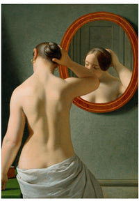 Woman looking in a mirror, adjusting her hair.