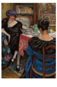 Two women at a table, with tea, in a room.