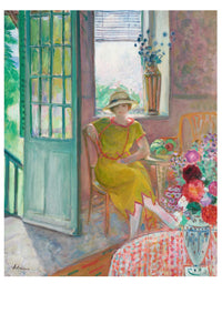 Woman in yellow dress seated near open door.