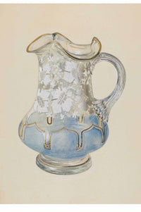 Glass pitcher with floral design and blue base.