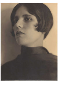 Woman with bob haircut looking off to the side.