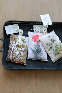 Orange bee sachet with floral design on tray.