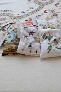Bee sachets with floral and bee designs.