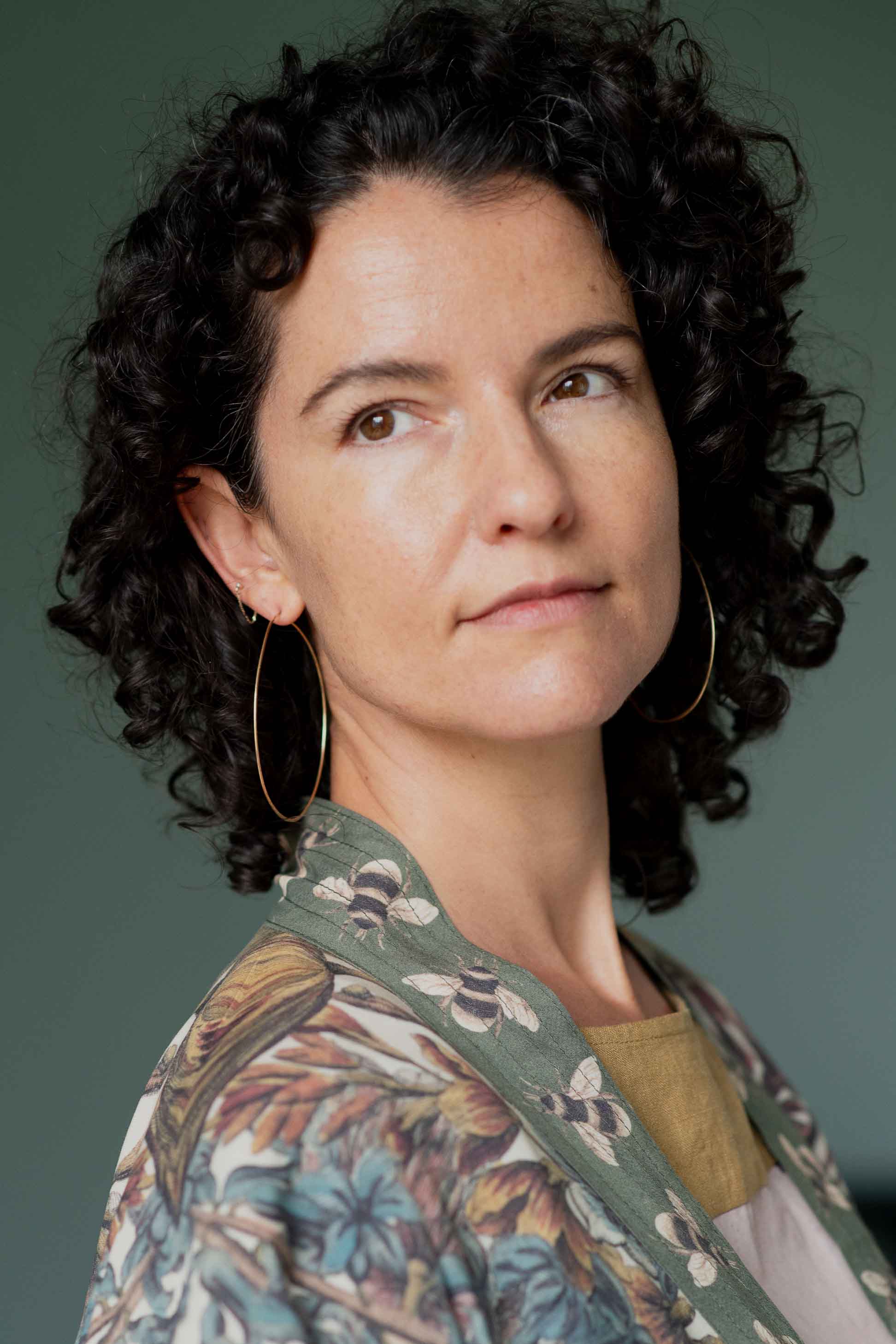 Woman wearing brass hoop earrings