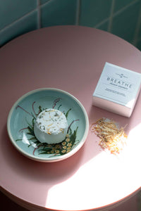 Breathe shower steamer on a decorative plate