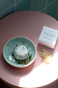 Breathe shower steamer on a decorative plate