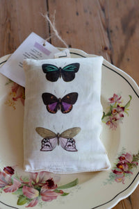 Butterfly scented sachet on floral plate