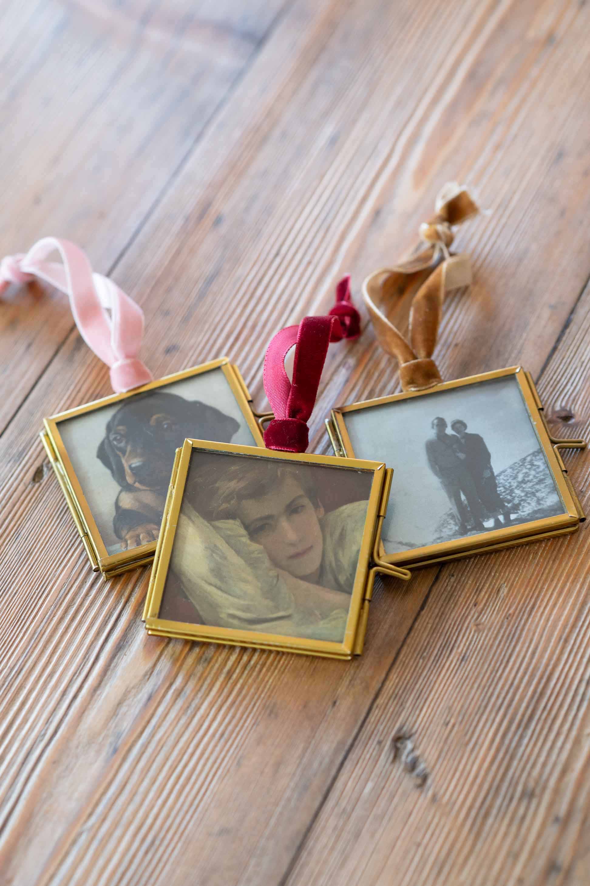 Framed photos with velvet ribbon, on wooden surface