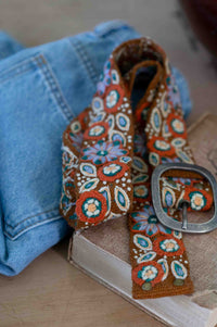Embroidered floral belt on jeans and book - DSC5071