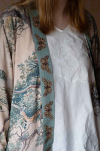 Woman wearing Earth Sky Kimono Tilly Top with butterfly trim.