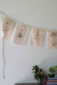 Flower girl garland with embroidered flags.