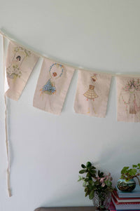 Flower girl garland with embroidered flags.