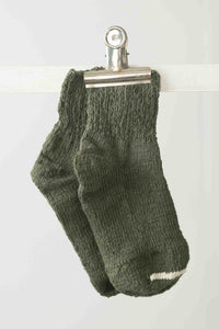 Garabou Khaki socks clipped to a line