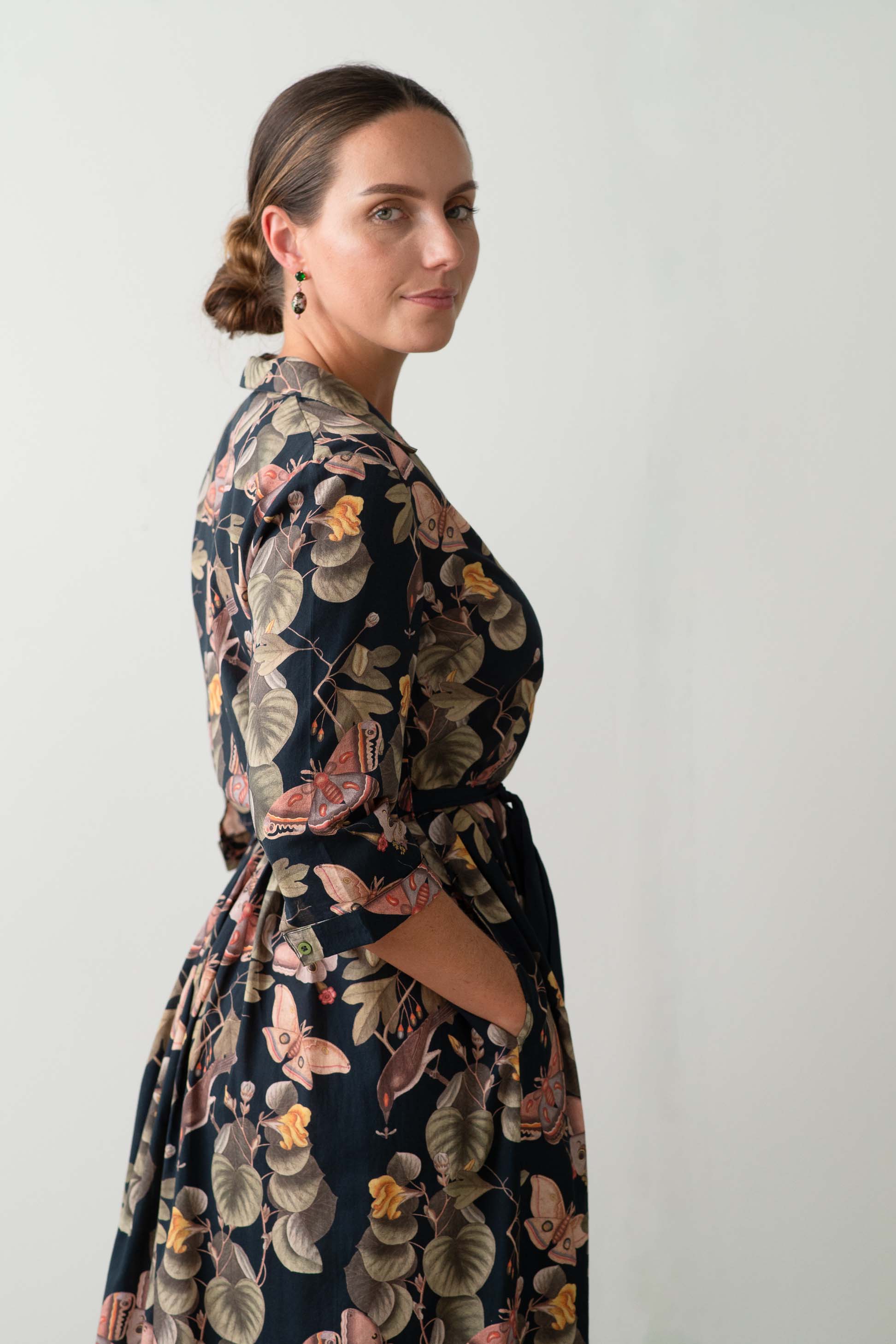 Gianna Merian in floral dress, side view.