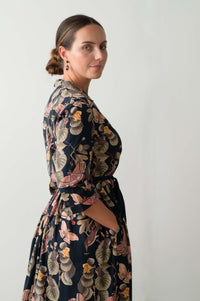 Gianna Merian in floral dress, side view.