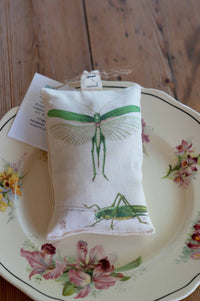 Grasshopper scented sachet on floral plate