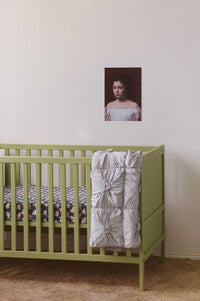 Grey marle cot quilt and prairie cot sheet in kids room with art print.