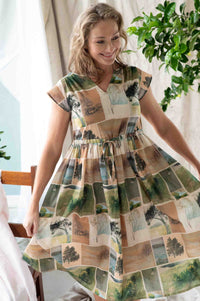 Woman in landscape print dress