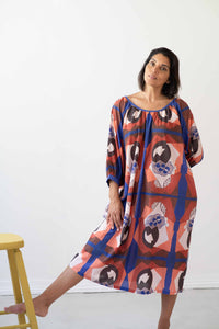 Hetti Composition dress, woman in colorful patterned outfit.