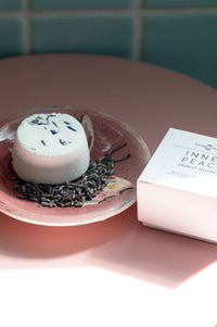 Inner Peace shower steamer on a pink plate