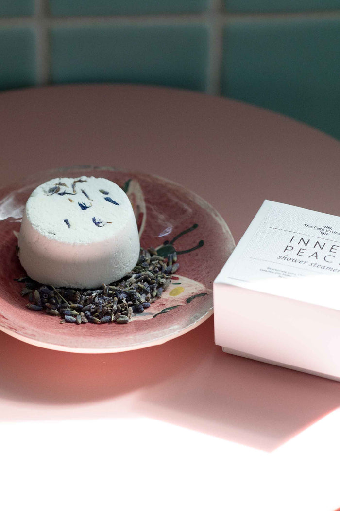 Inner Peace shower steamer on a pink plate