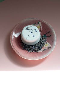 Inner Peace Shower Steamer on pink dish