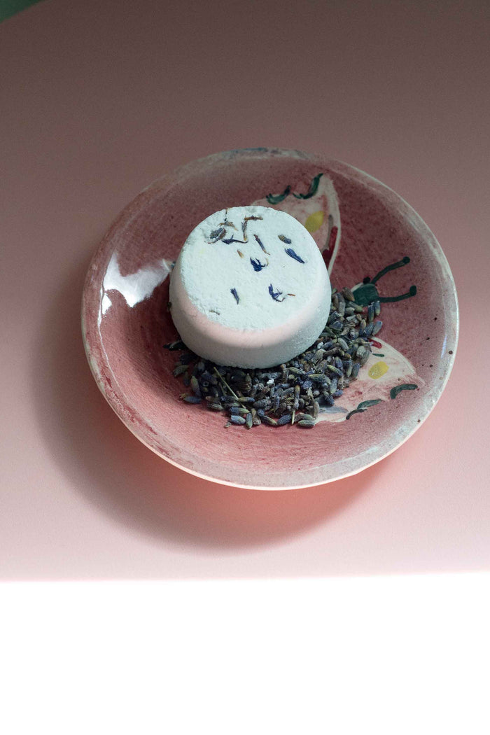 Inner Peace Shower Steamer on pink dish