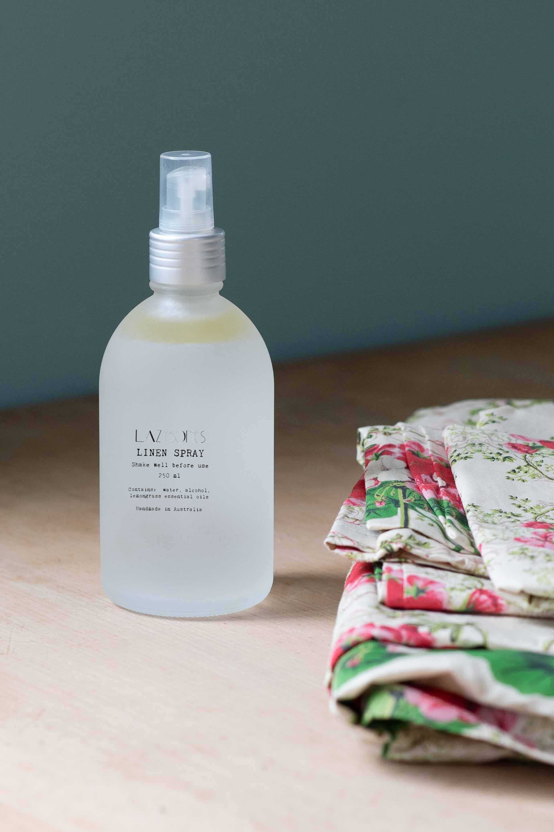 Lemongrass linen spray bottle next to floral fabric