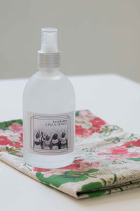 Linen spray bottle on floral cloth