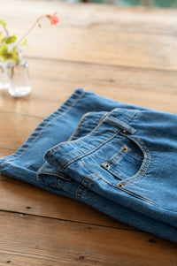 NicoJeans blue denim jeans on wooden table