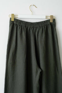 OllieThyme green linen pants on hanger