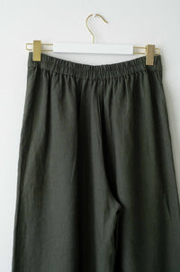 OllieThyme green linen pants on hanger