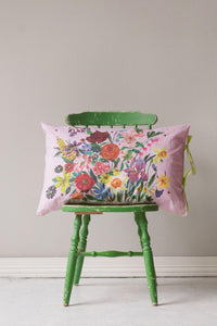 Pink floral pillowcase on green chair