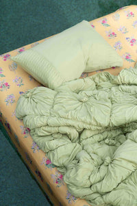 Rosette Green Tea Summerland Sheets with a green pillow and quilt