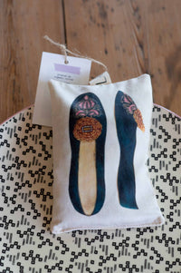 Scented slipper sachets on patterned surface