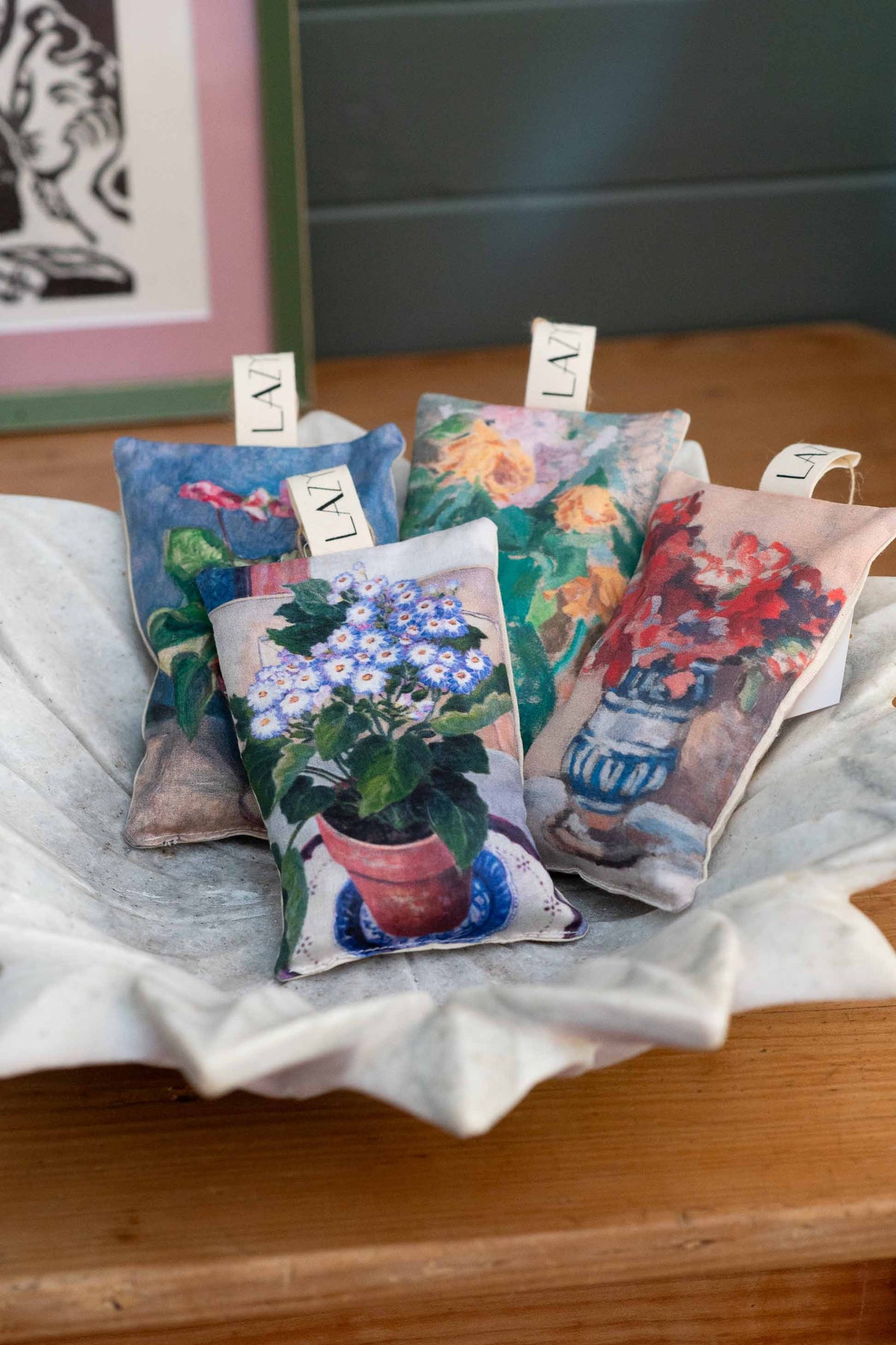 Still life of scented sachets with floral designs.