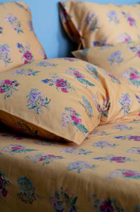 Summerland floral pillowcase on bed