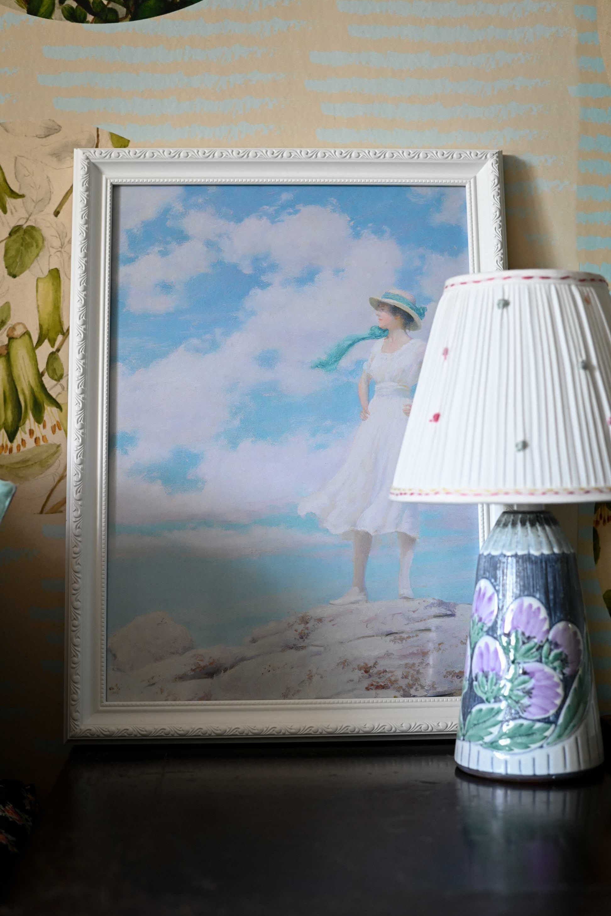 Woman in white dress with blue sky background