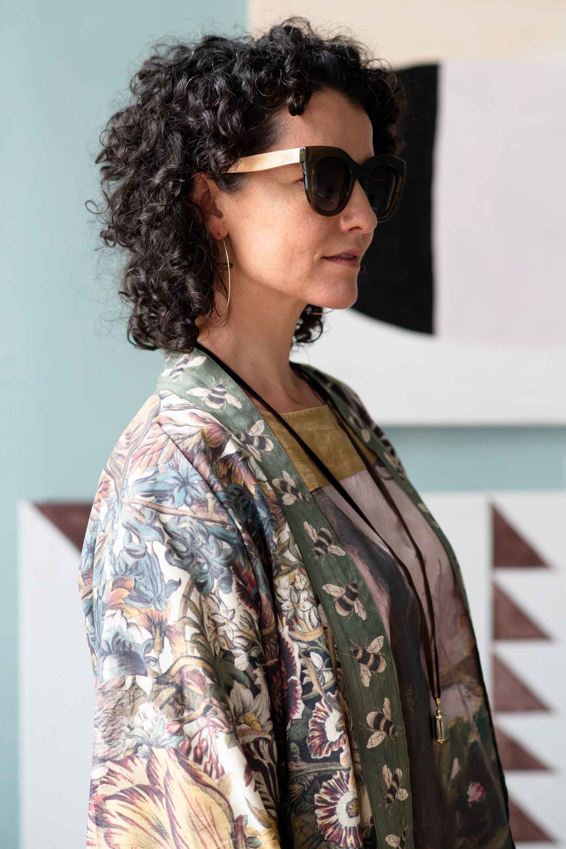 Woman wearing sunglasses and floral kimono