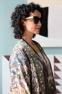 Woman wearing sunglasses and floral kimono