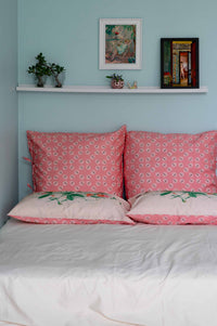 Sweetpea Flutter pillows on bed