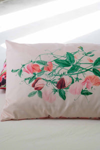 Sweetpea floral pillow on bed