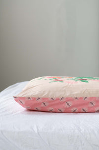 Sweetpea pillow with floral design on white bed