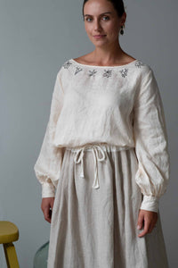 Valeria in cream Fion skirt, long-sleeved blouse with embroidery
