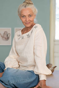 Valeria in cream top and denim jeans
