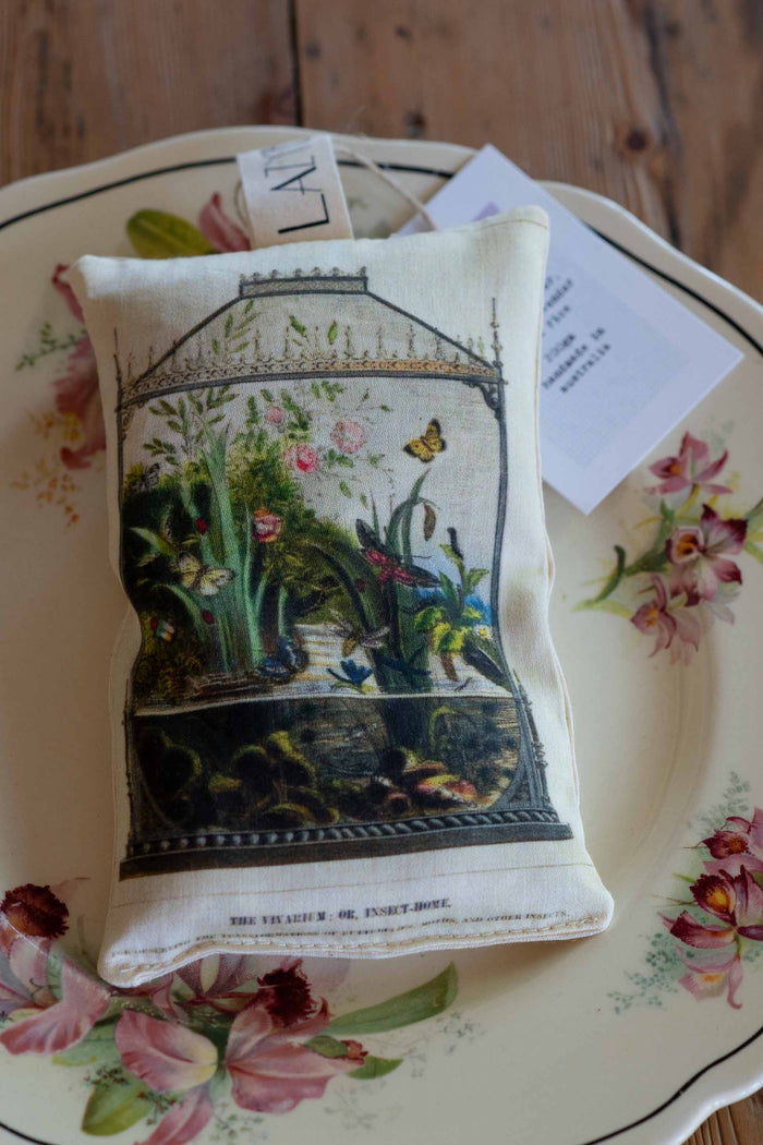 Vivarium-themed scented sachet on floral plate
