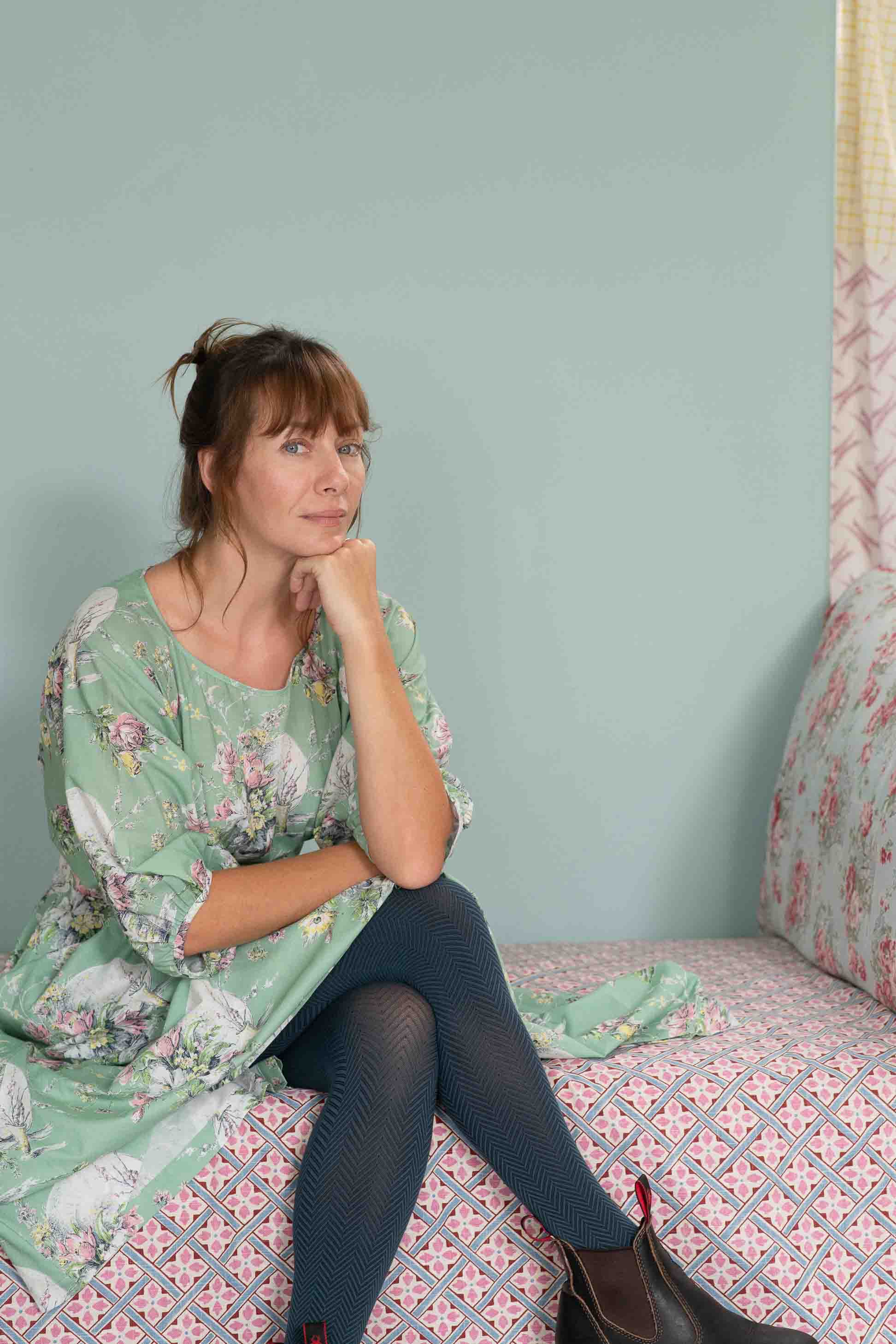 Woman in blue tights and floral dress, Faith Newlyn