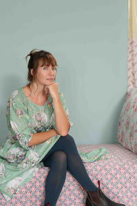 Woman in blue tights and floral dress, Faith Newlyn