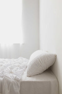 White rosette quilt pillowcase set on bed