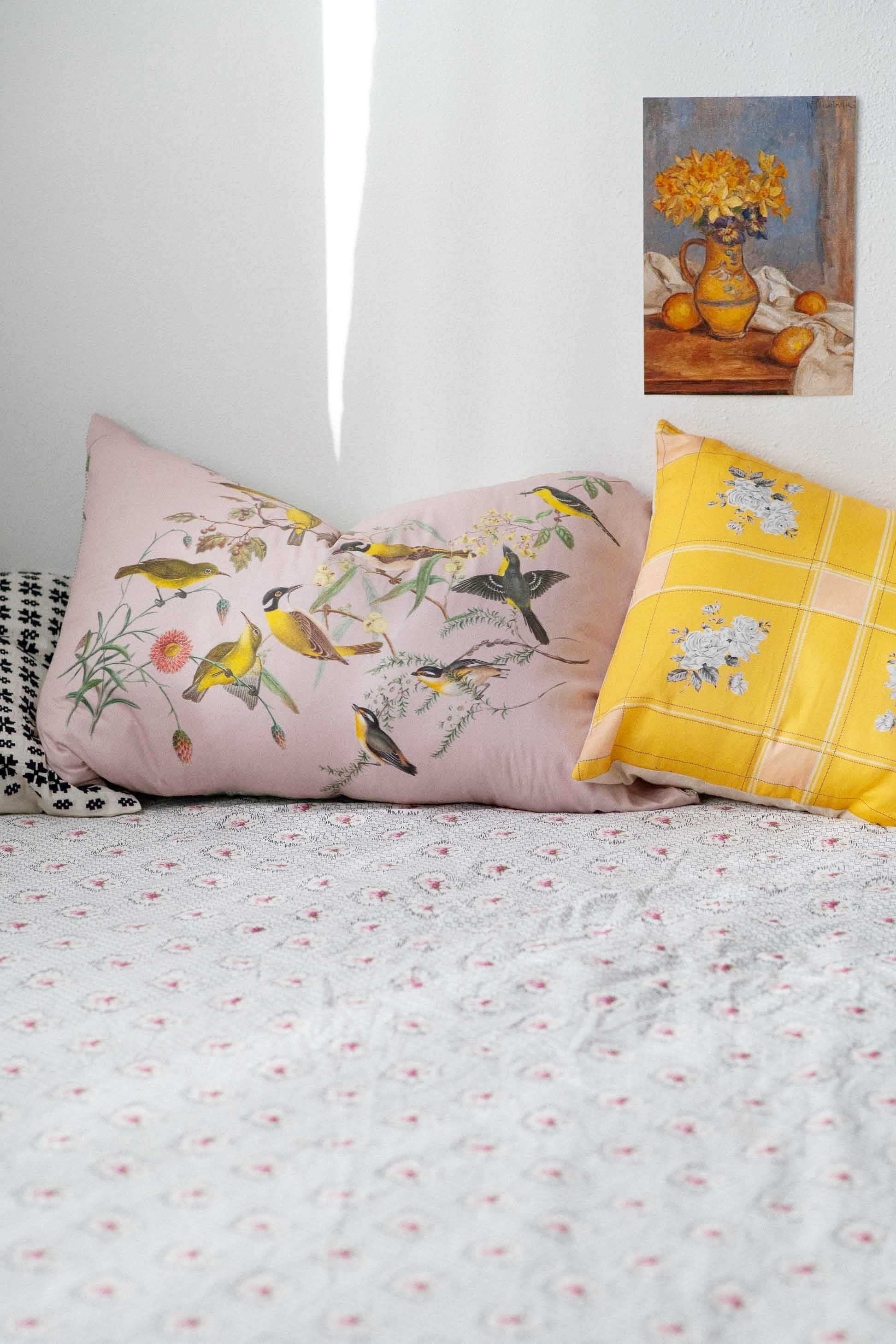 Yellow bird cushions on bed, Vienna